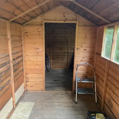 New timber boards and framing fitted inside a garden shed partition