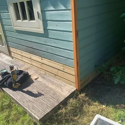 Replacement lower wall boards and corner trim fitted to a summerhouse