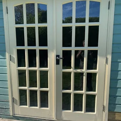 Existing glazed summerhouse double doors after careful repair