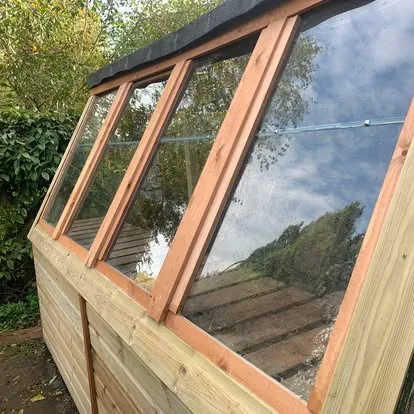 Rotten potting-shed front being replaced with new structural timber